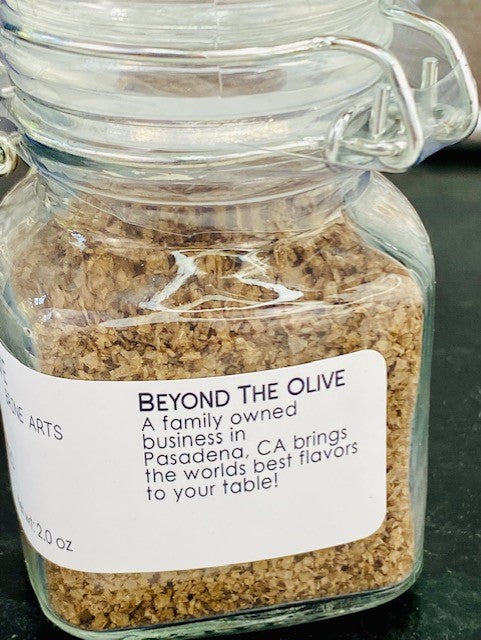 
                  
                    Load image into Gallery viewer, Close up of small glass jar filled with Applewood smoked sea salt. Listed information of Manufacturer Beyond The Olive, a family owned business in Pasadena, CA.
                  
                