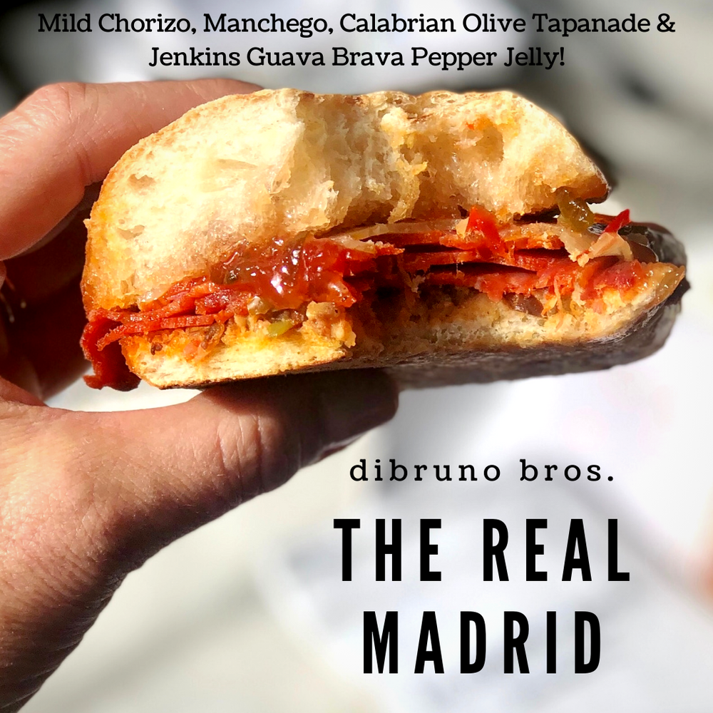 
                  
                    Load image into Gallery viewer, Guava Brava hot pepper jelly is perfect on sandwiches. The Real Madrid specialty gourmet sandwhich offered at Di Bruno Bros. in Philadelphia. Mild Chorizo, Manchego, Calabrian Olive Tapanade &amp;amp; Jenkins Jellies Guava Brava Pepper Jelly on a Ciabatta roll. Make it extraordinary.
                  
                