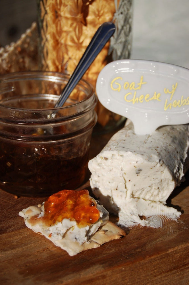 
                  
                    Load image into Gallery viewer, Small jar of Hell Fire Pepper Jelly with spoon with breadsticks and goat cheese. One cracker is shown spread with goat cheese with herbs and ontop sits a dollop of the sweet and savory hot pepper jam. A great partner for your cheese board offerings. A party appetizer that is a crowd pleaser. Make it extraordinary.
                  
                